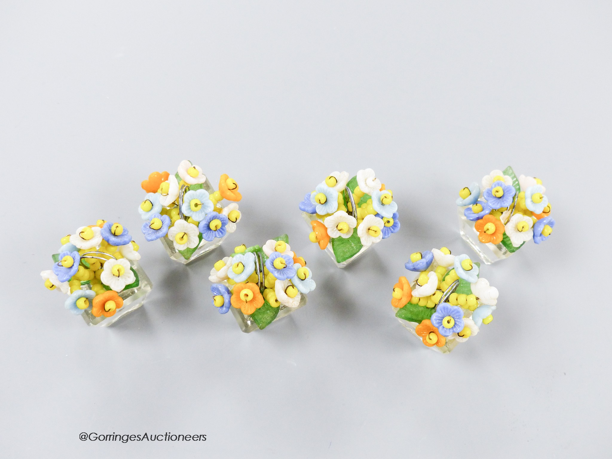 A boxed set of six Czechoslovakian glass flower menu holders, height 3.5cm